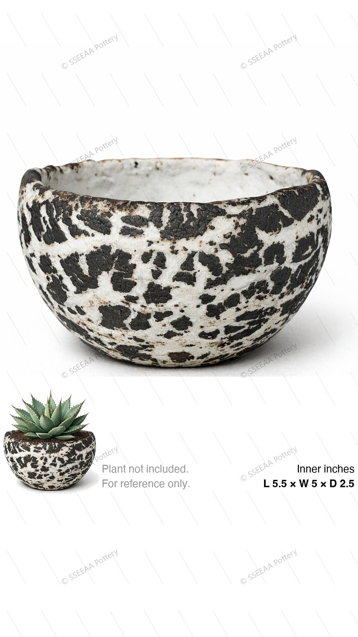 A shallow bone-white speckled pot with bold black patchwork finish and rounded rim.