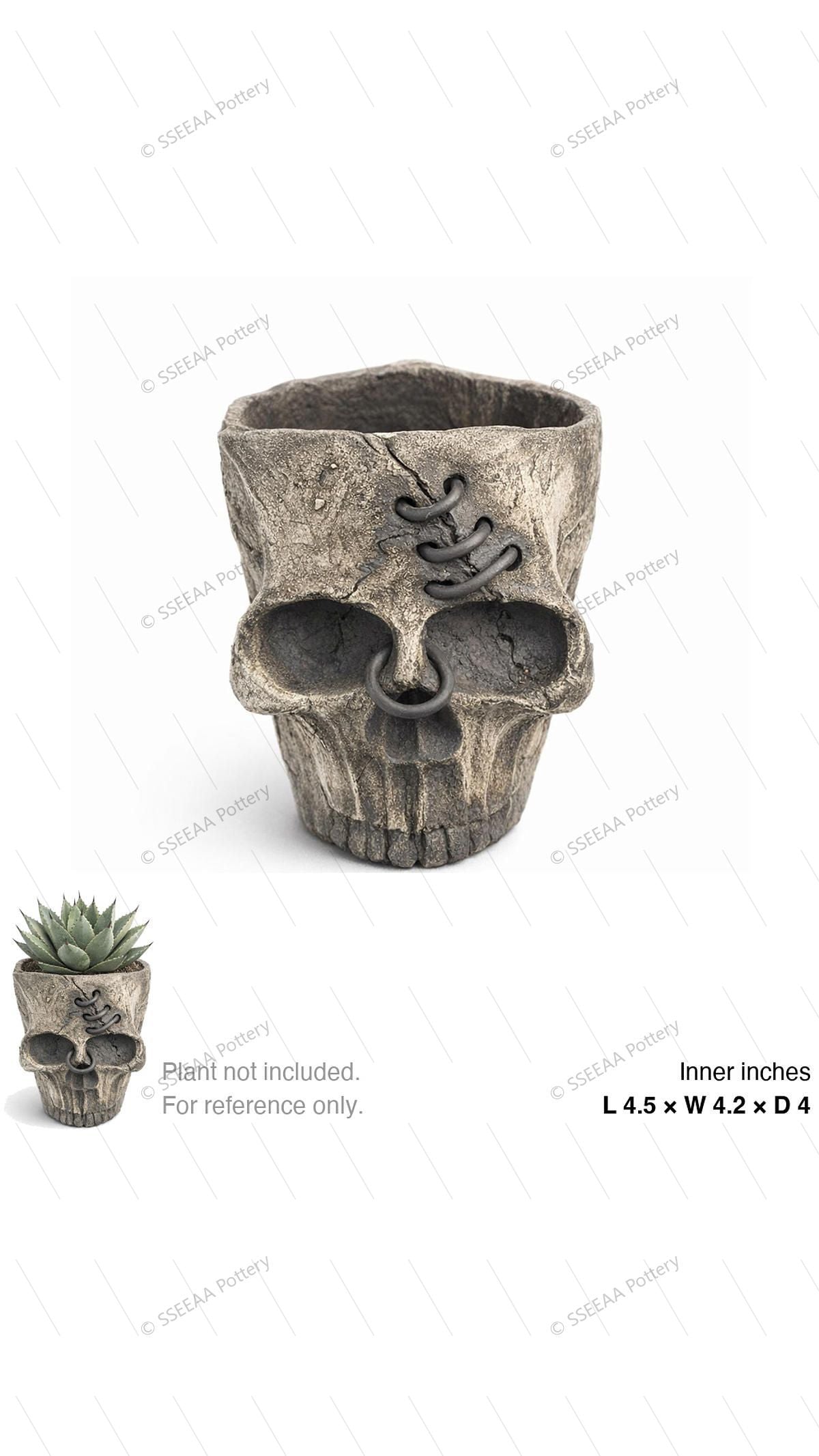 Weathered skull-shaped tabletop pot with open top and carved facial detail