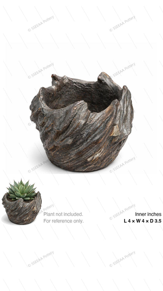 Dark weathered decorative pot with a rugged open rim and sculptural textured surface.