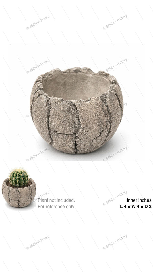 Rounded sand-toned textured pot with a rugged stone-like surface