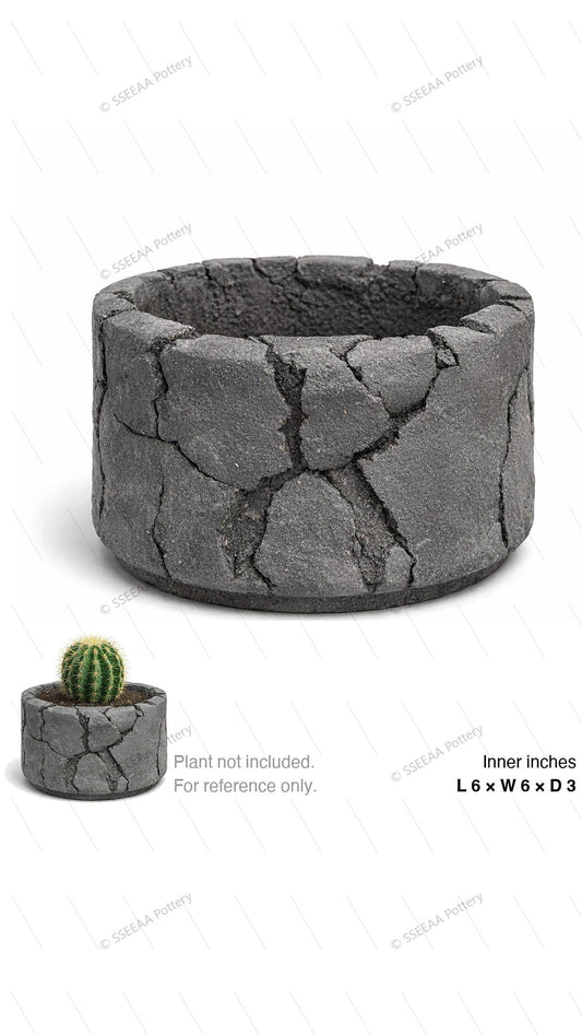 Dark gray round pot with a cracked stone-like surface and wide opening.