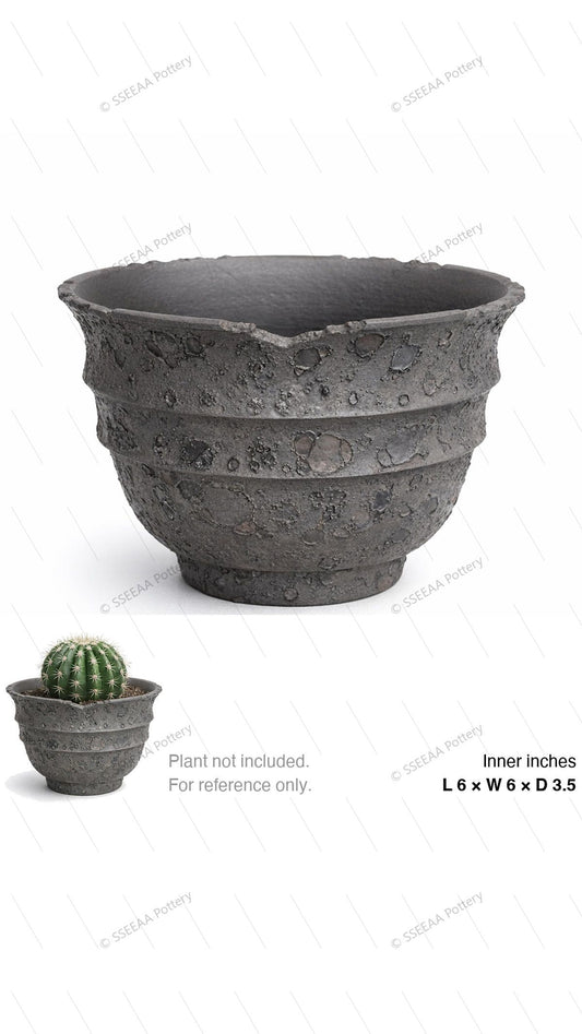 Textured storm-gray footed pot with cratered surface and wide rim