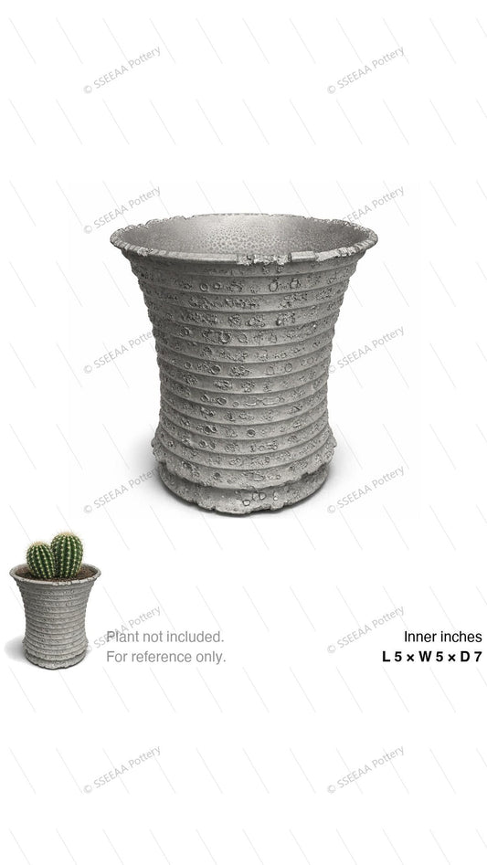 Textured gray fluted pot with a wide rim and tapered profile
