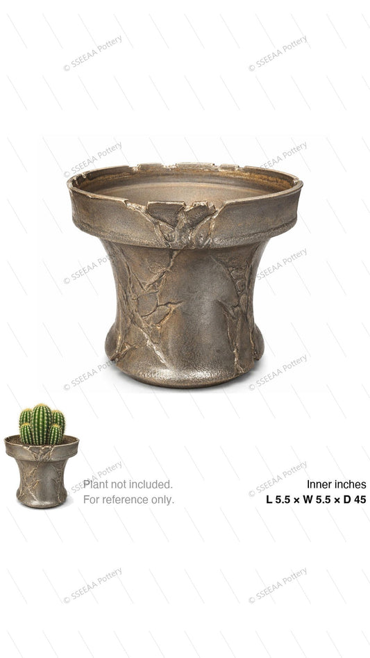 Textured bronze footed pot with a wide rim and rugged cracked surface