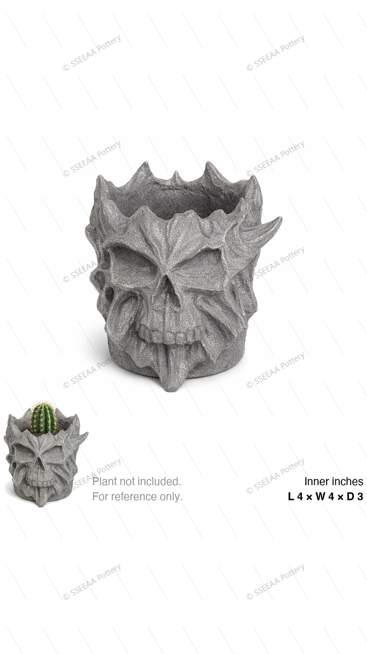 Gray skull-faced decorative pot with a sculptural rocky surface and raised rim details, shown with a small cactus for scale.