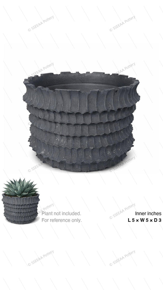 Dark charcoal ribbed round pot with flared rim and rugged textured bands