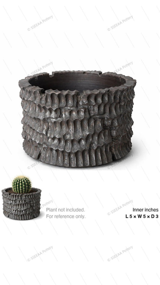 Charcoal textured round pot with craggy rim and dark weathered finish