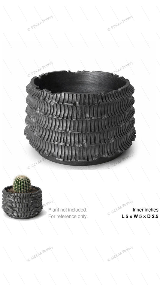 Dark ribbed ceramic-style pot with rounded profile and wide opening
