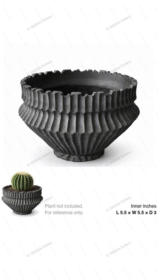 Charcoal ribbed footed pot with flared rim and sculptural textured body