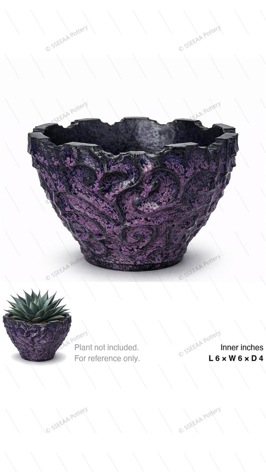 Textured purple and black decorative pot with a rugged sculpted surface and wide open rim.